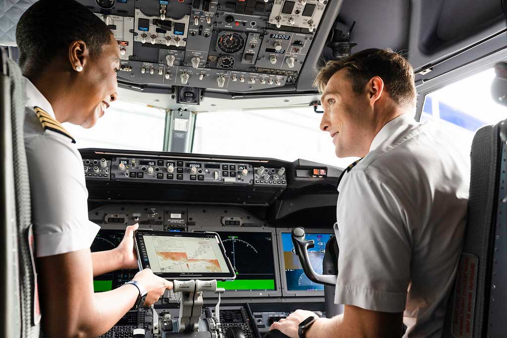 A pilot and co-pilot in the cockpit of a aircraft