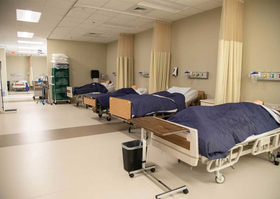 mannequins in hospital beds in a nursing classroom