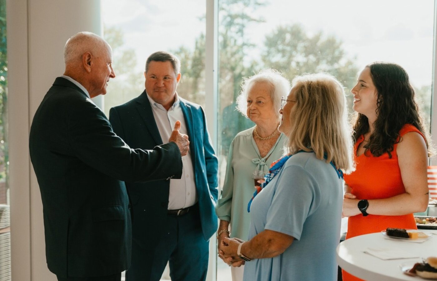 Colonel Tillman in a conversation with the Jennings Family members during reception