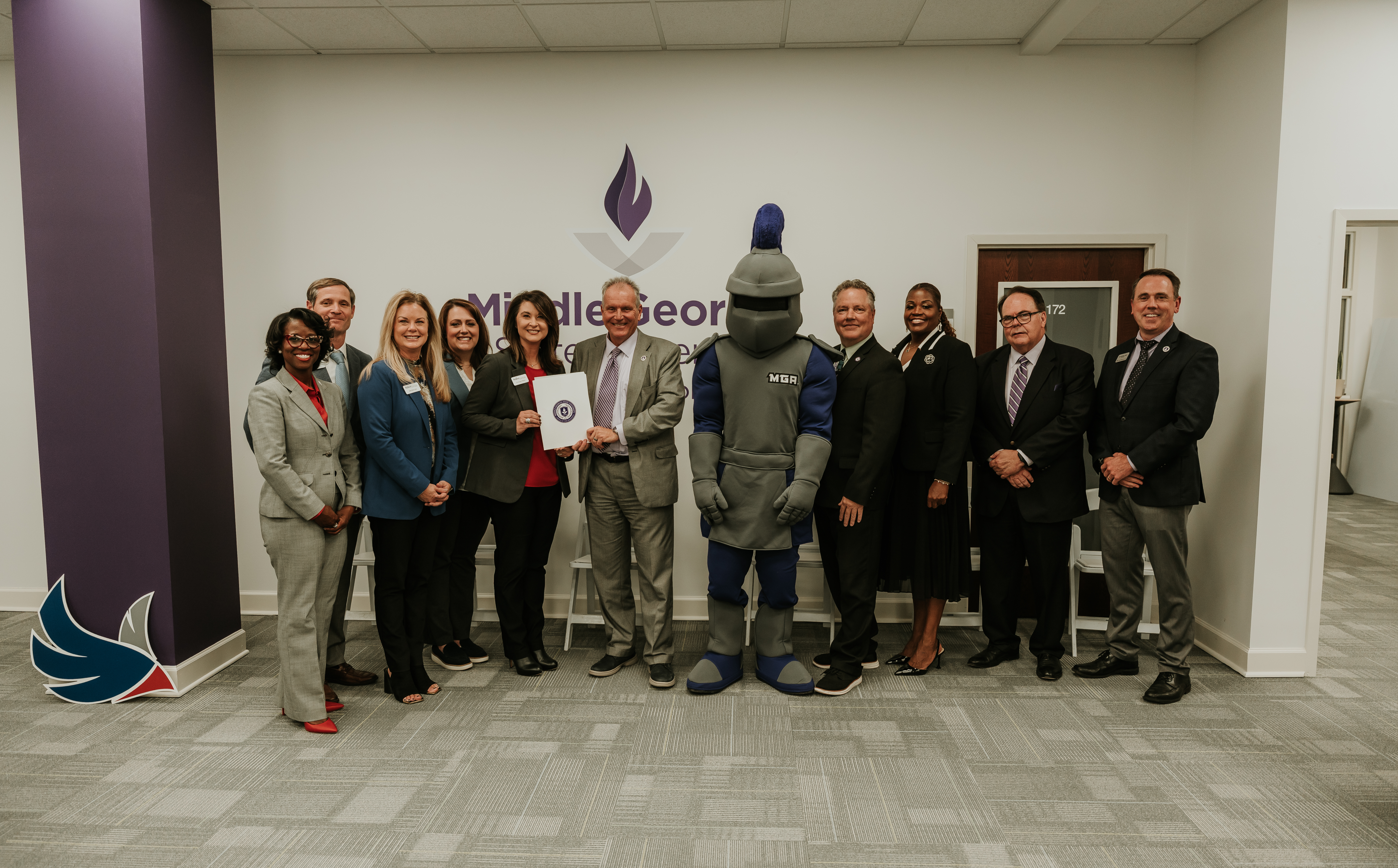 robins federal representative stand with MGA representatives and knight mascot Duke
