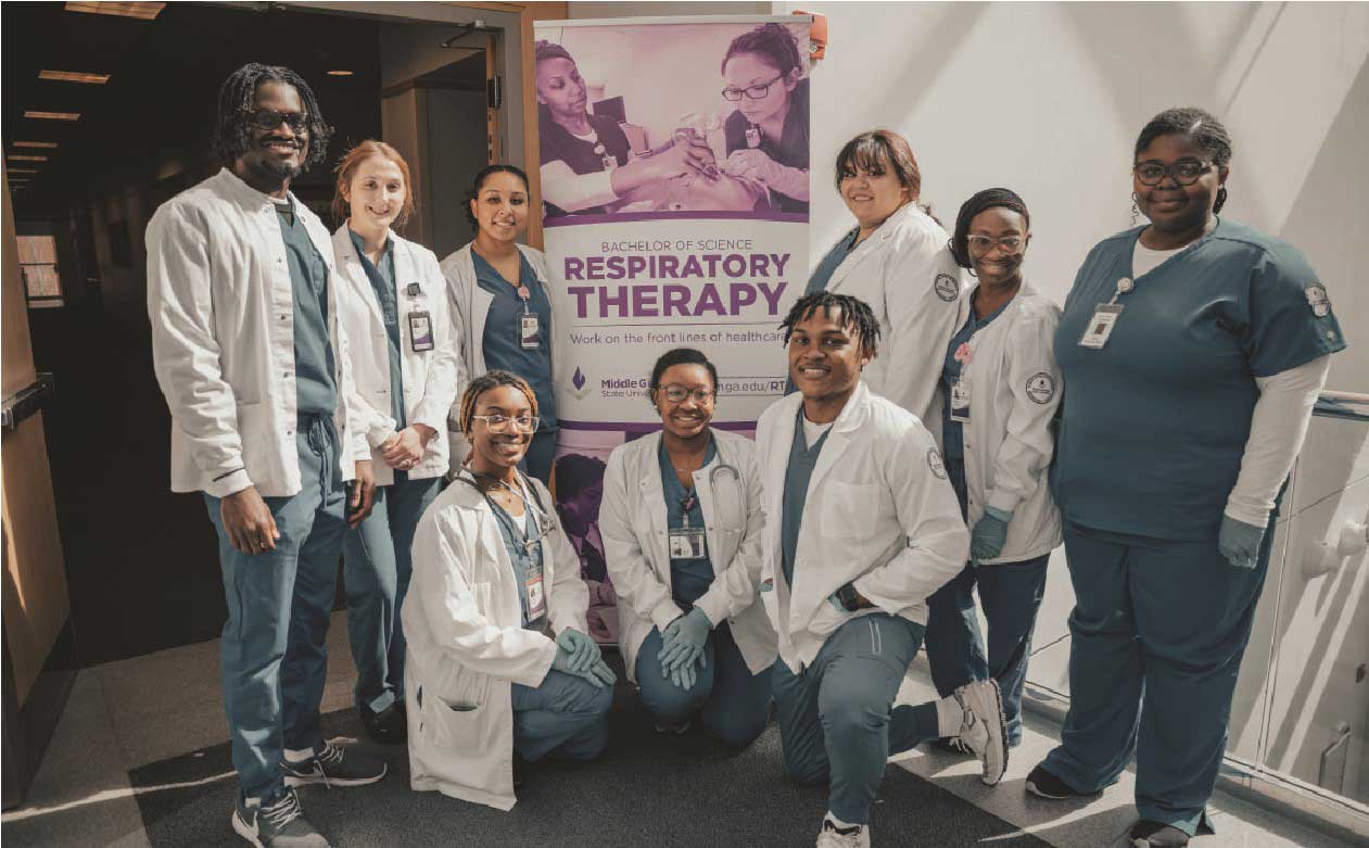 Nine NBRC students in scrubs and white coats